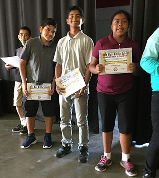 Students pose with certificates