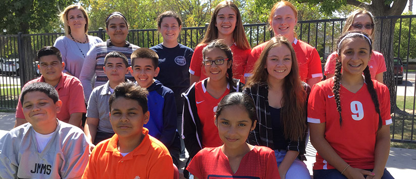 Students pose together outside