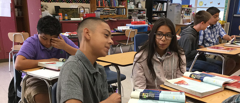 Students sit at their desks in a classroom